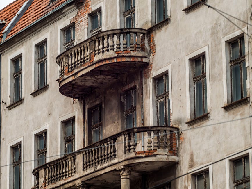 Photography of a historic, weathered building showcasing unique, rustic balconies and architectural details.
